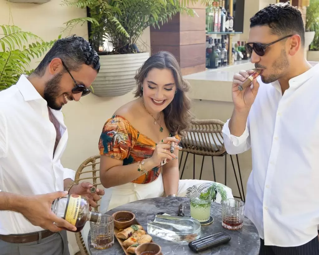 A group of people celebrating with the best 4th of july cigars  and rum from Leon Jimenes